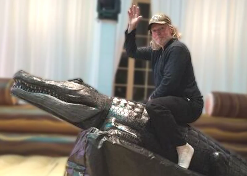 Guest riding Chomps mechanical alligator mechanical ride rental and attraction rental at a Florida party